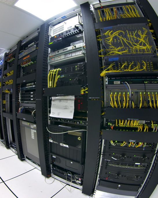 Telecommunications equipment in one corner of a small data center.
