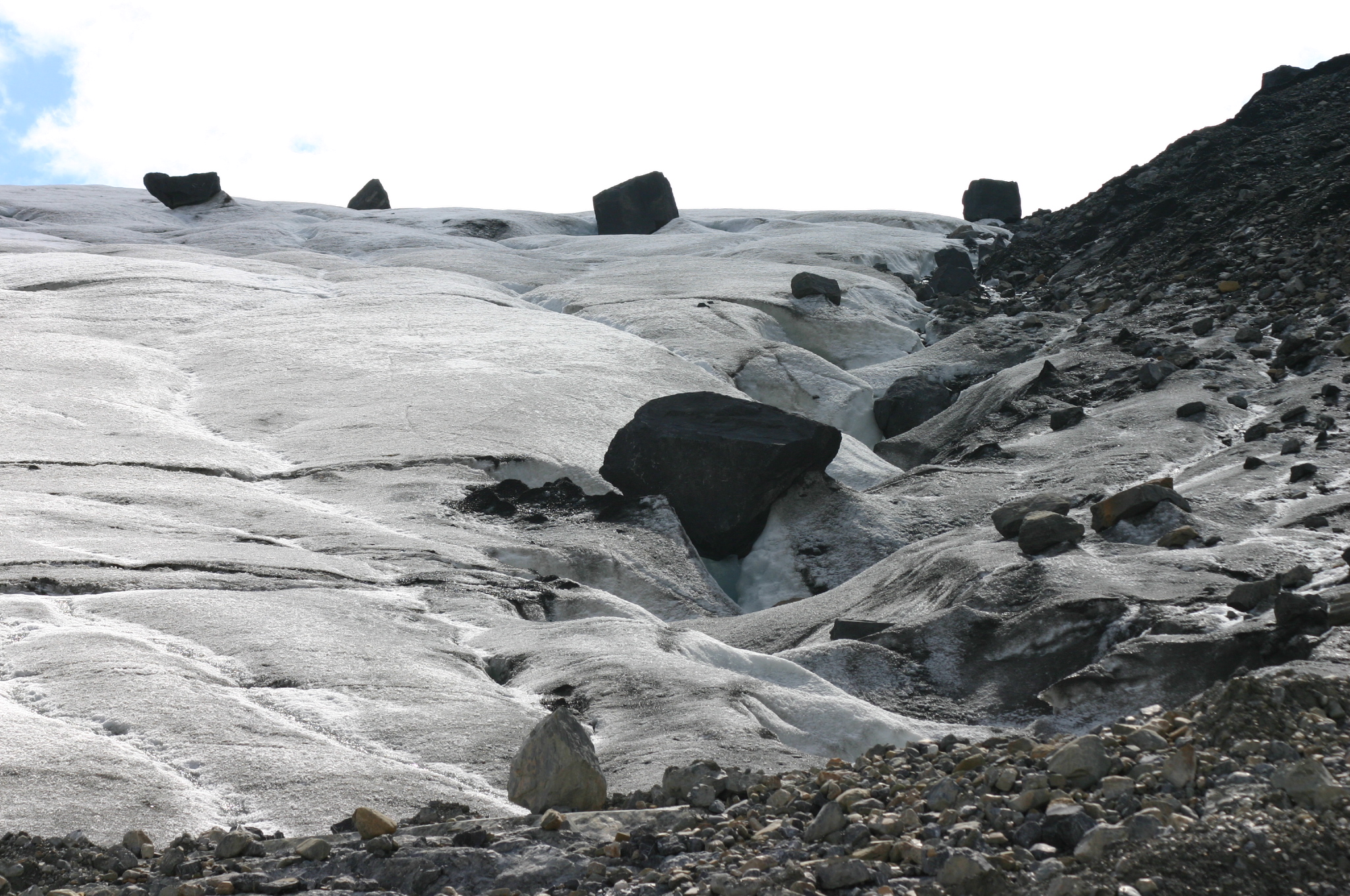 A glacier transports many boulders downstream. As the glacier retreats, these rocks were deposite...