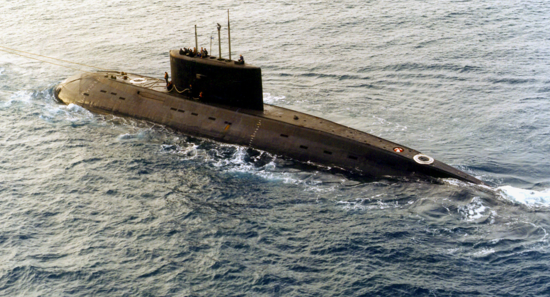 A Russian-built, Kilo-class diesel submarine recently purchased by Iran, is towed by a support ve...