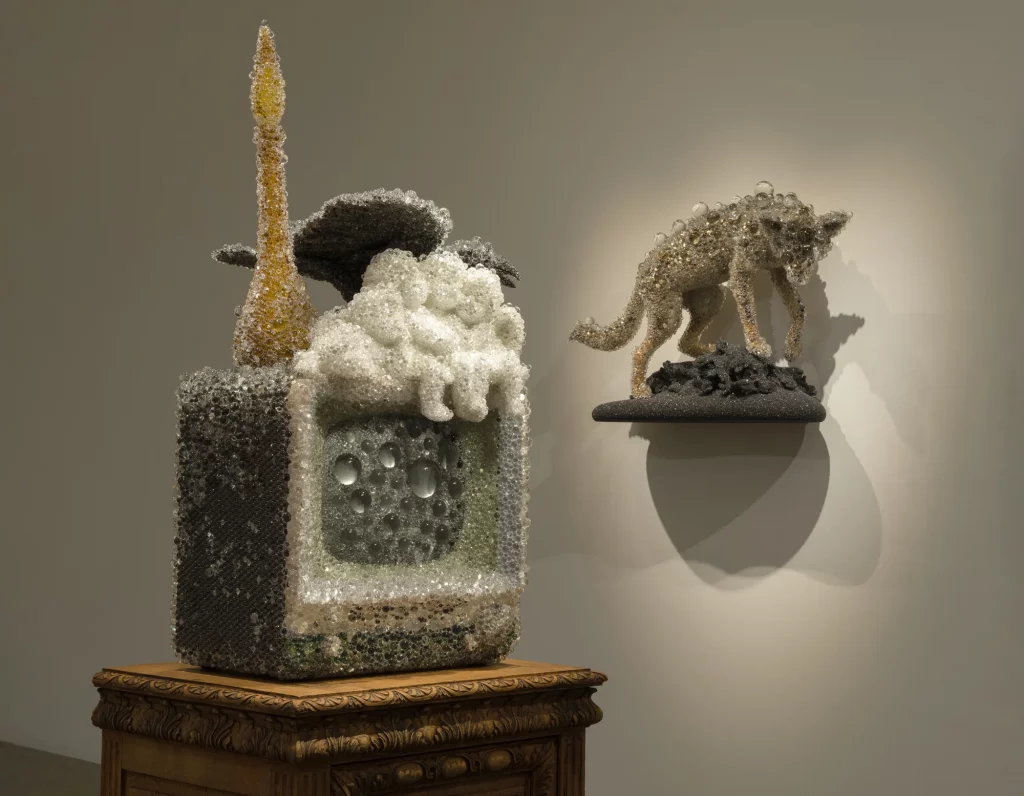 Installation view of Kohei Nawa’s Photon Camp at Pace Gallery, Los Angeles. A sculpture from the artist’s PixCell series sits atop an ornate wooden pedestal, while a taxidermied animal form covered in transparent spheres is mounted on the wall nearby.