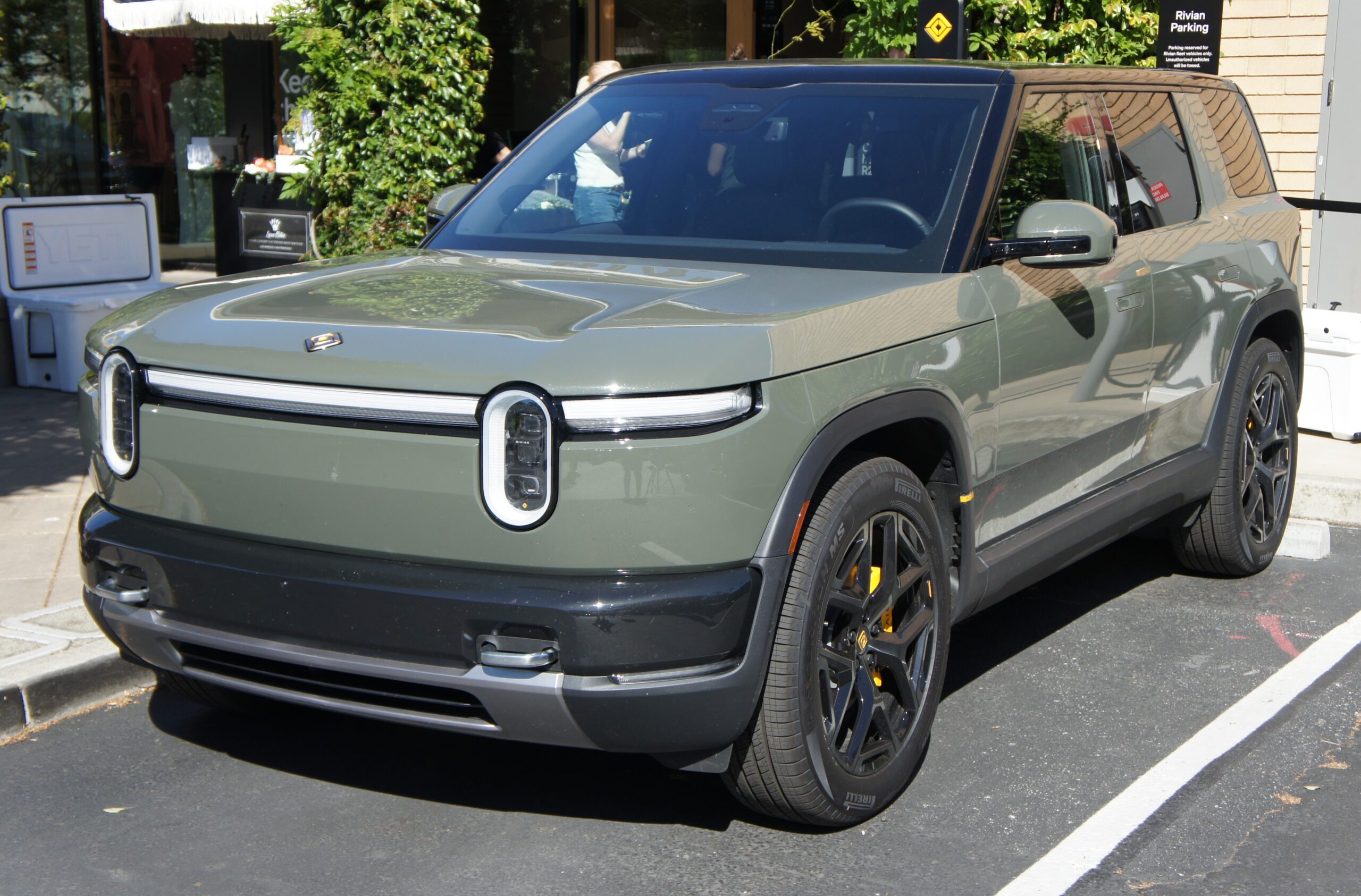 Rivian R2 in Launch Green parked outside Rivian Space in Stanford Shopping Center in Palo Alto, CA