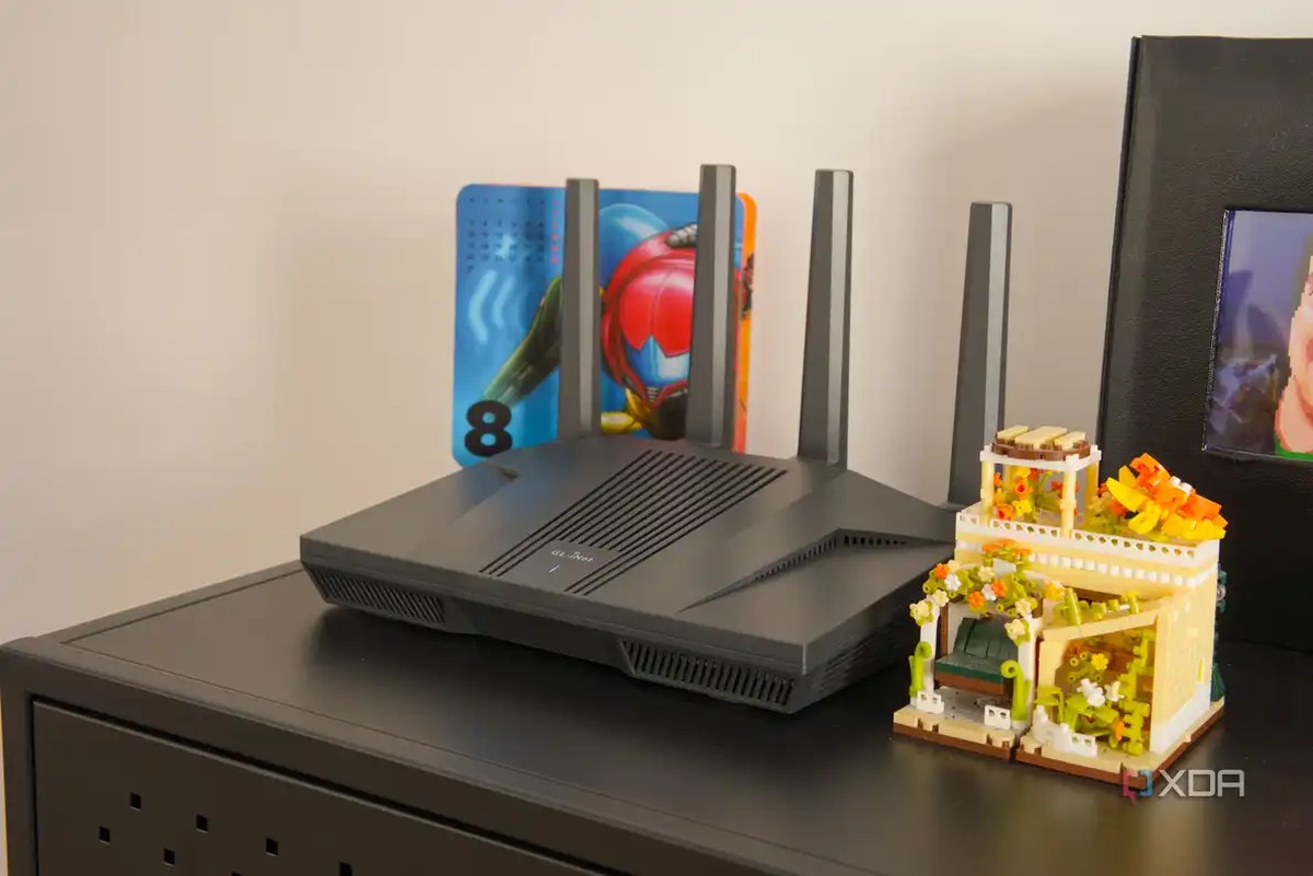 A Wi-Fi router on a black shelf with a calendar featuring video game artwork in the background