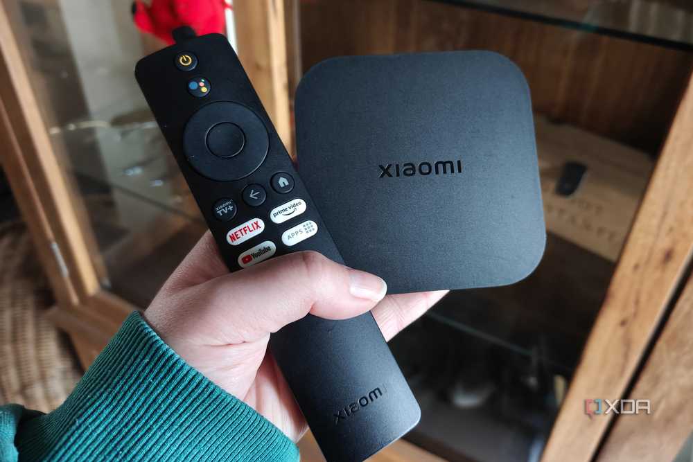 a xiaomi tv box with a remote