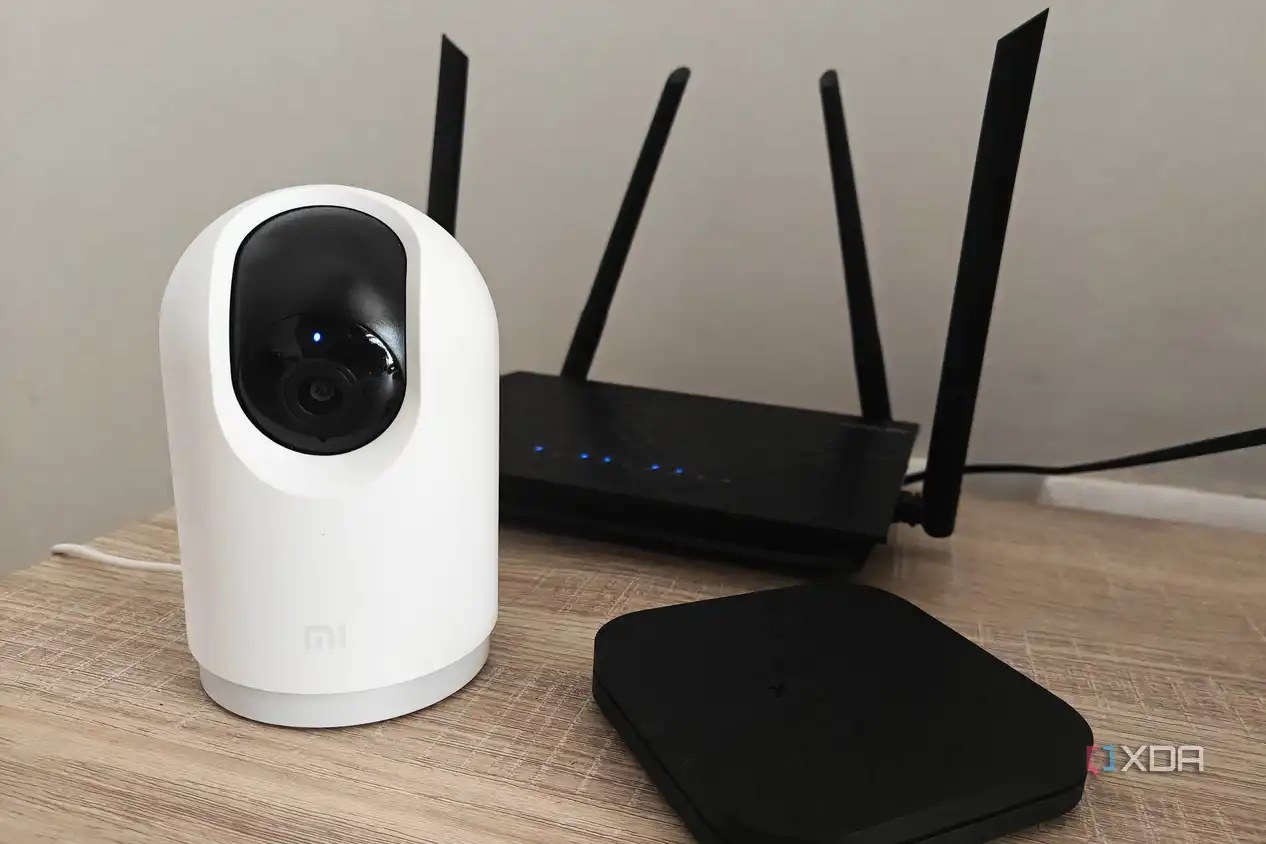 smart home devices on a table including a camera and tv box