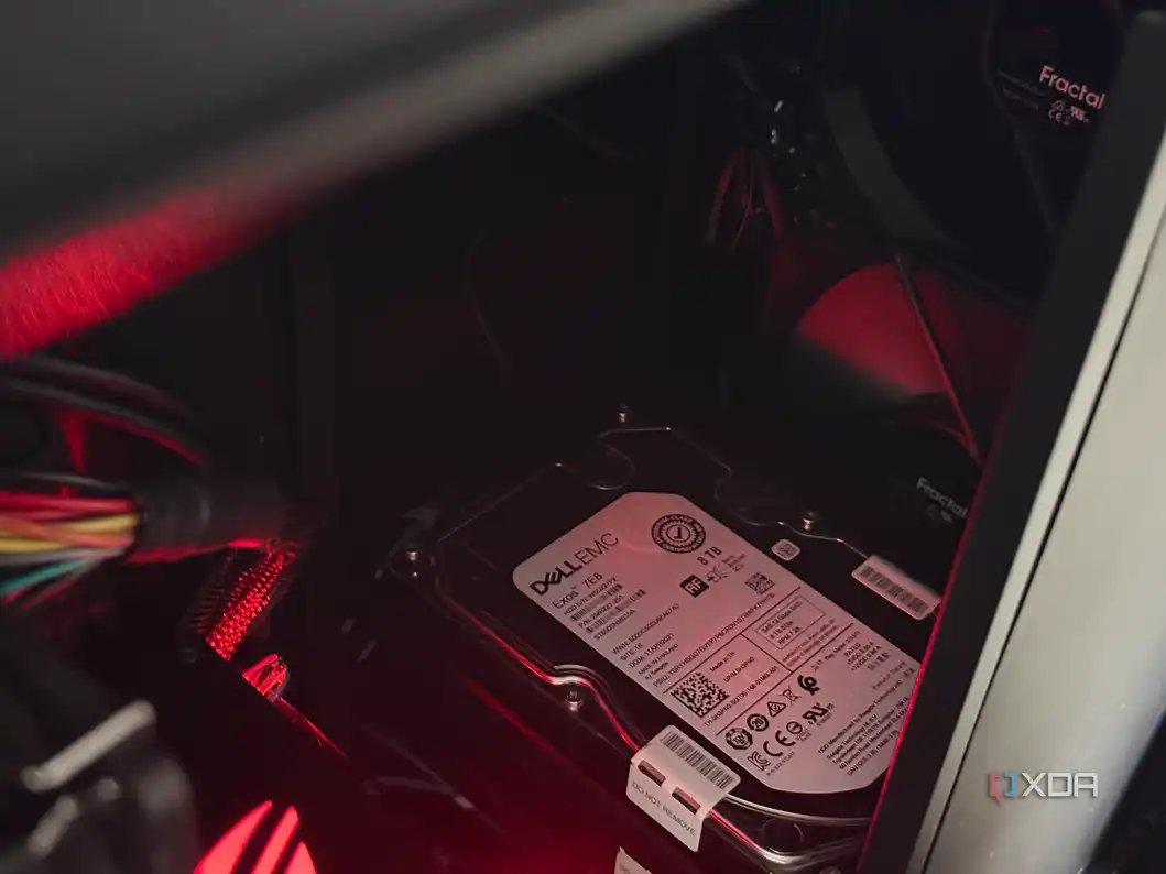 A photo of a couple of SAS drives installed in the front of a case, with fans blowing across them