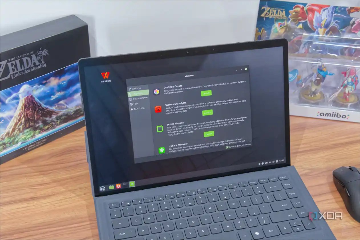A laptop running Linux Mint and showing the welcome screen with various steps the user can take to set up the computer