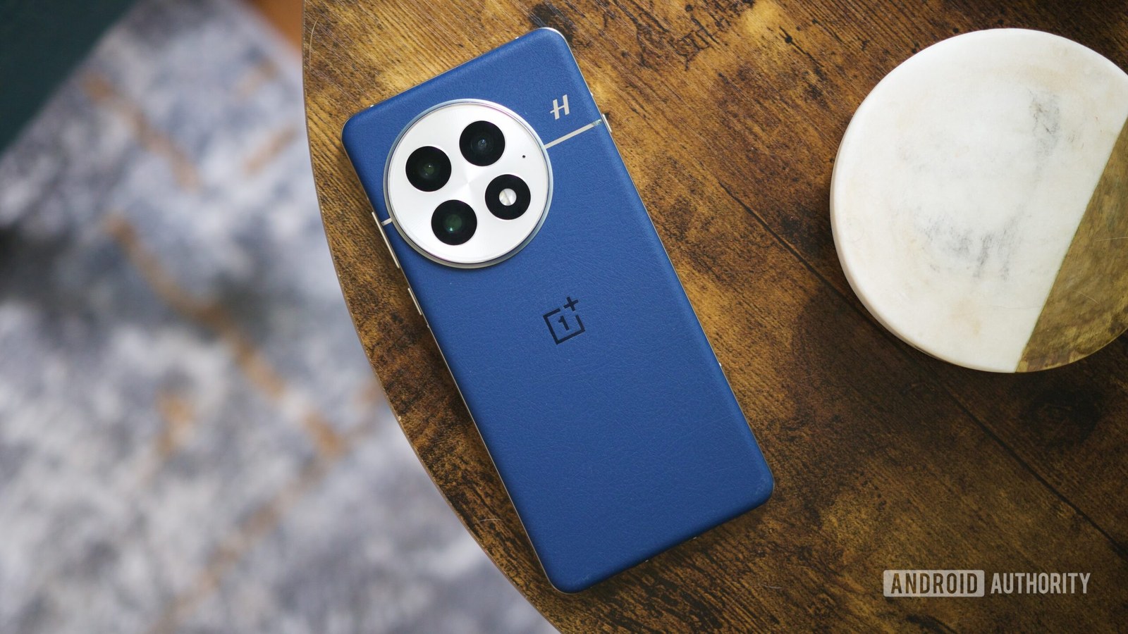 A OnePlus 13 laying face-down on a table.