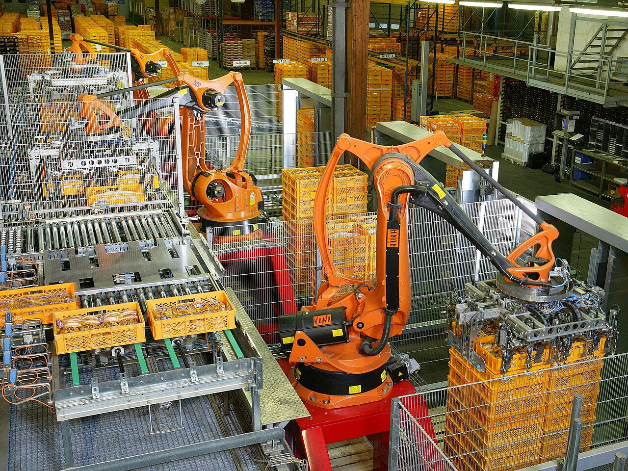 Factory automation with KUKA industrial robots for palletizing food products like bread and toast at a bakery in Germany