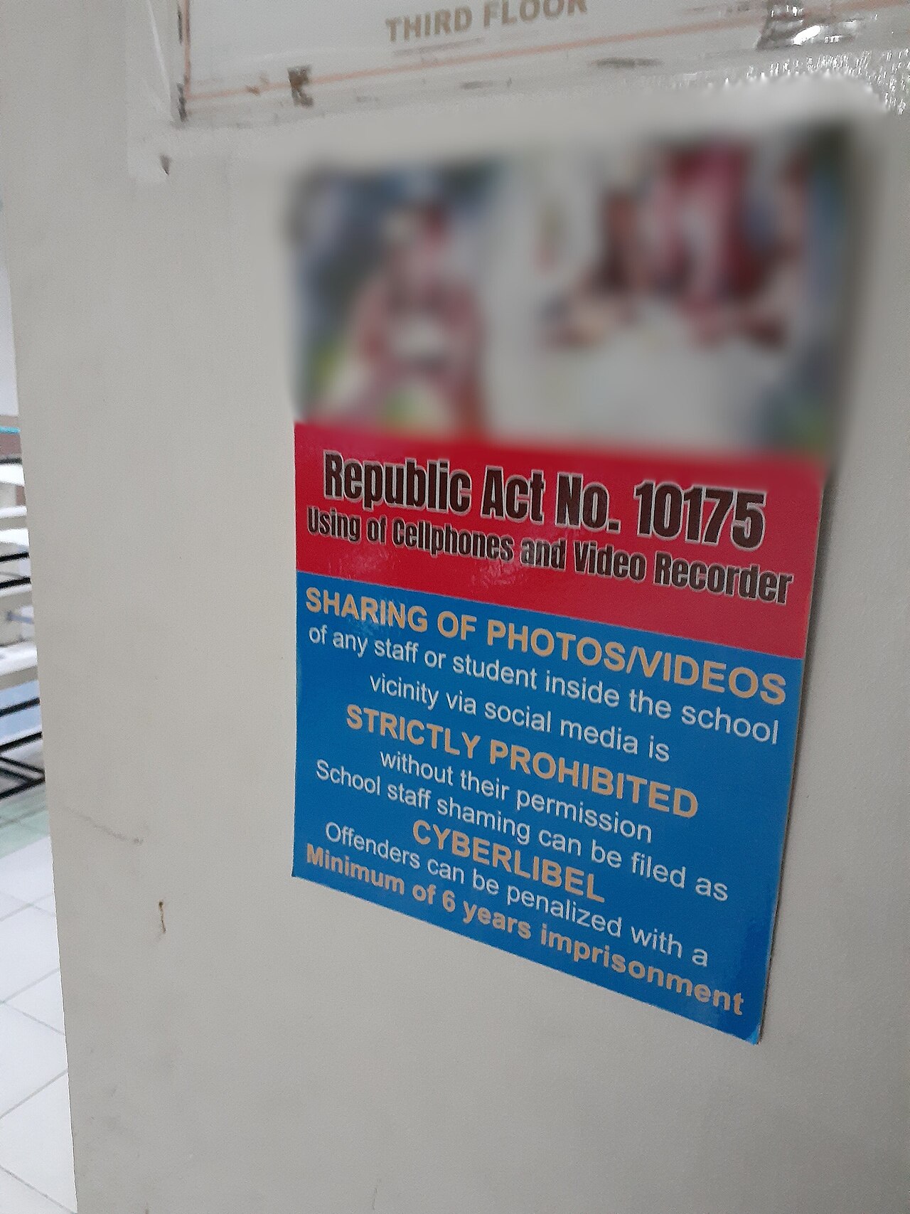 A sign in a Bulacan school informing that unpermitted sharing of photos or videos of students or staff is punishable courtesy of Cybercrime Prevention Act. Copyrighted stock image in the sign is blurred.