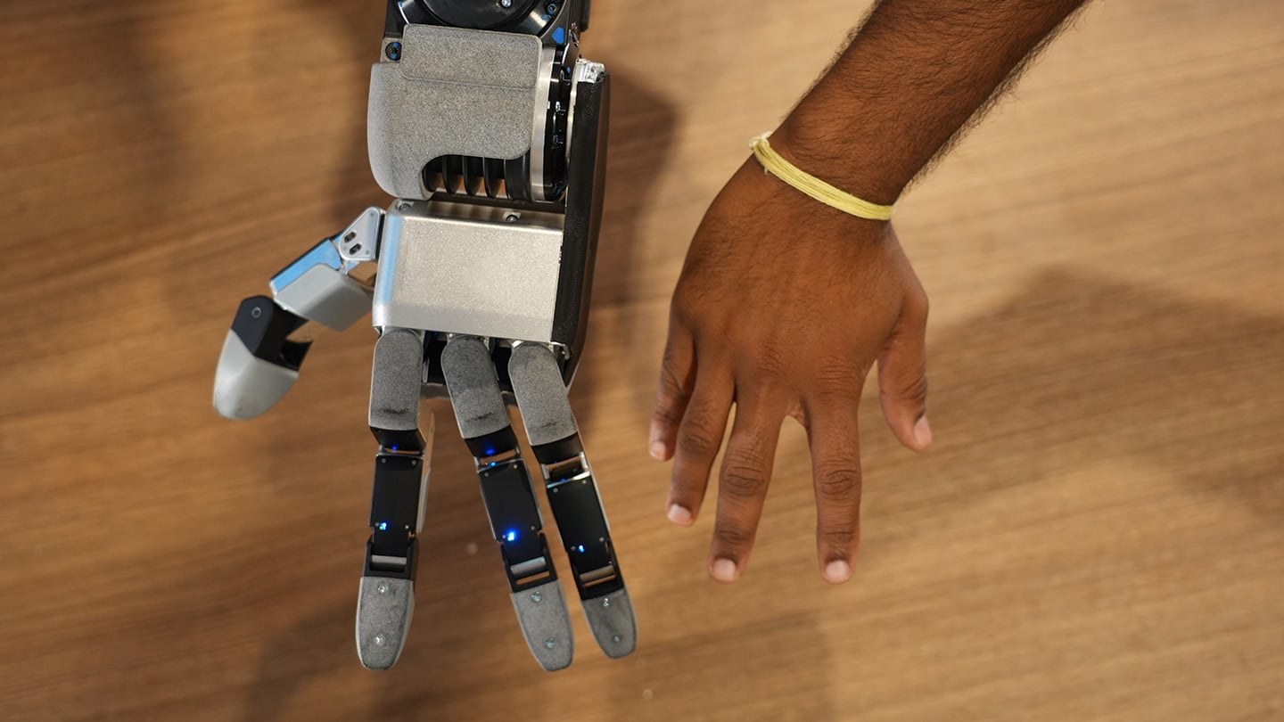 A human hand next to Atlas' new hand.