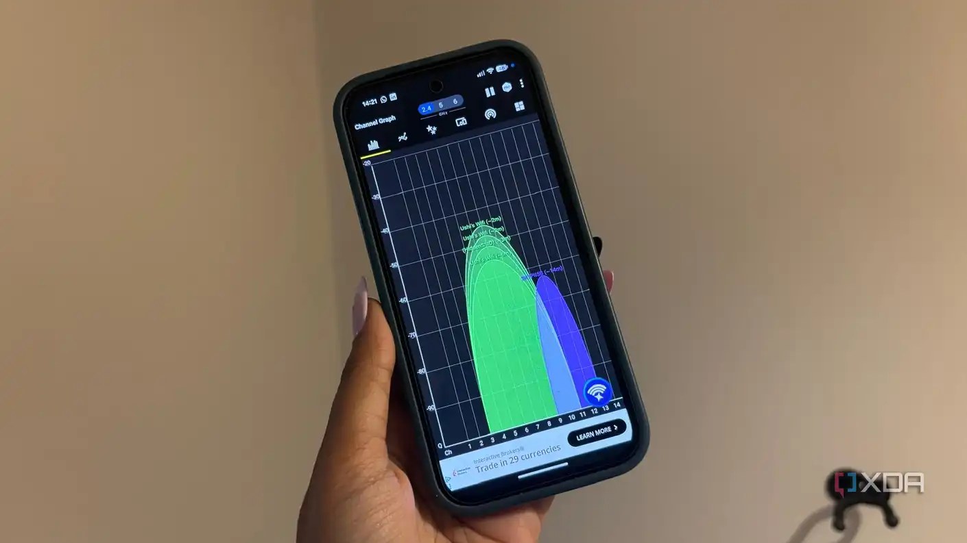 Wi-Fi analyzer app in use being held up on white background