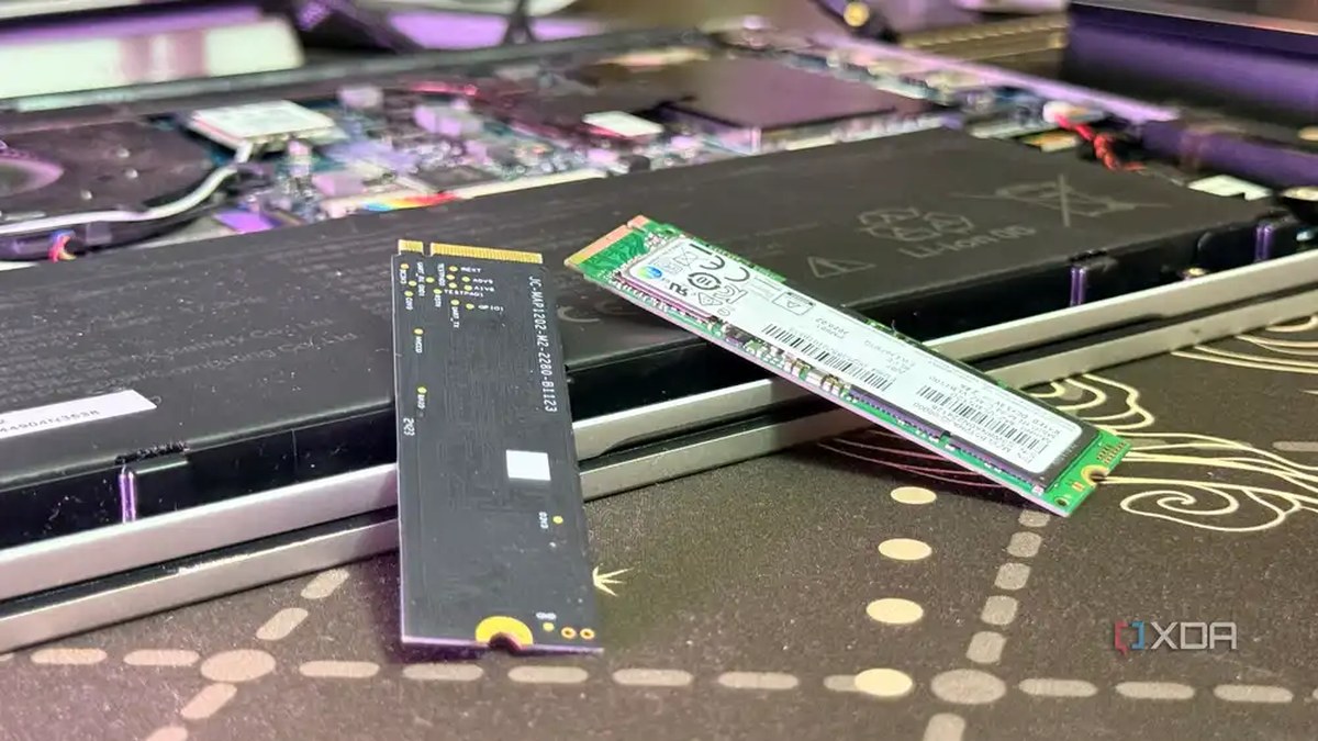 Two SSDs on top of a disassembled laptop
