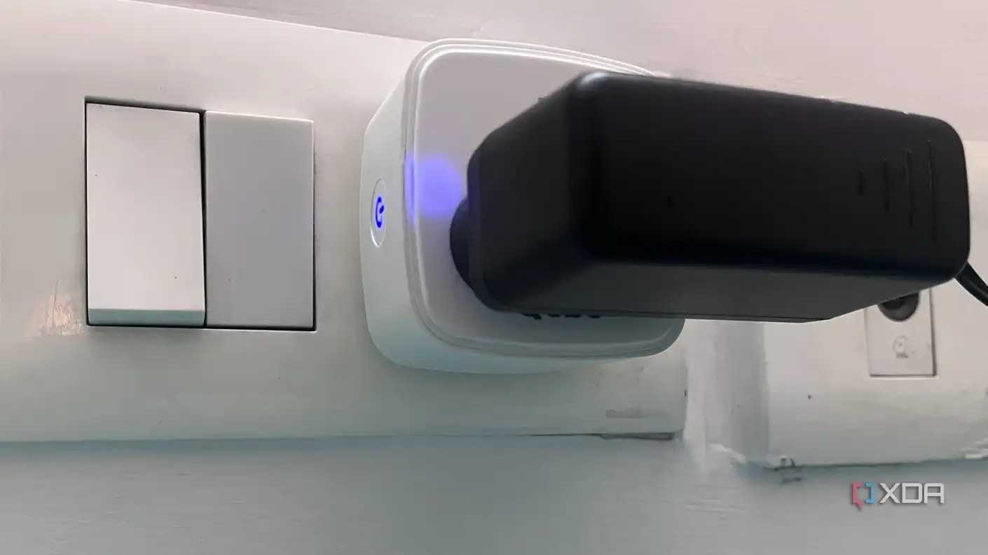 smart plug showing blue light with an adapter connected to it