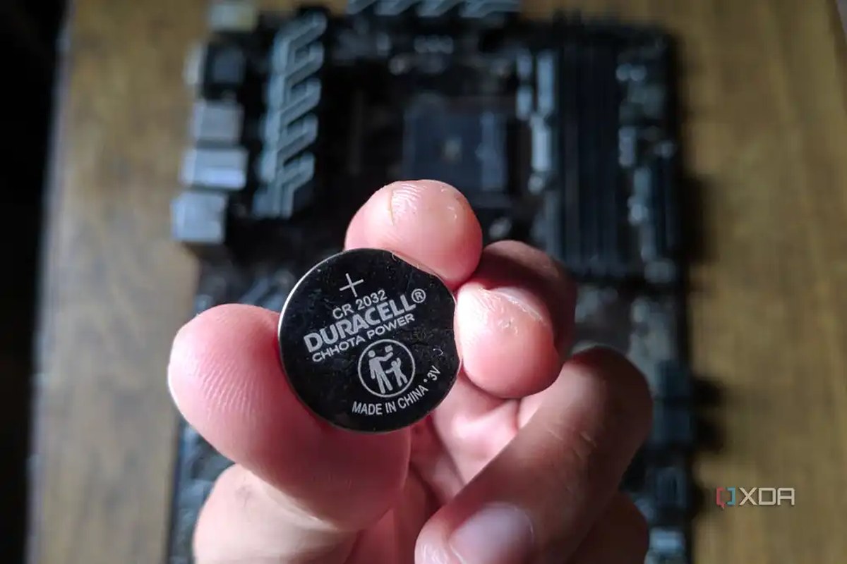 An image of a CMOS battery with the MSI B450 A-Pro motherboard in the background