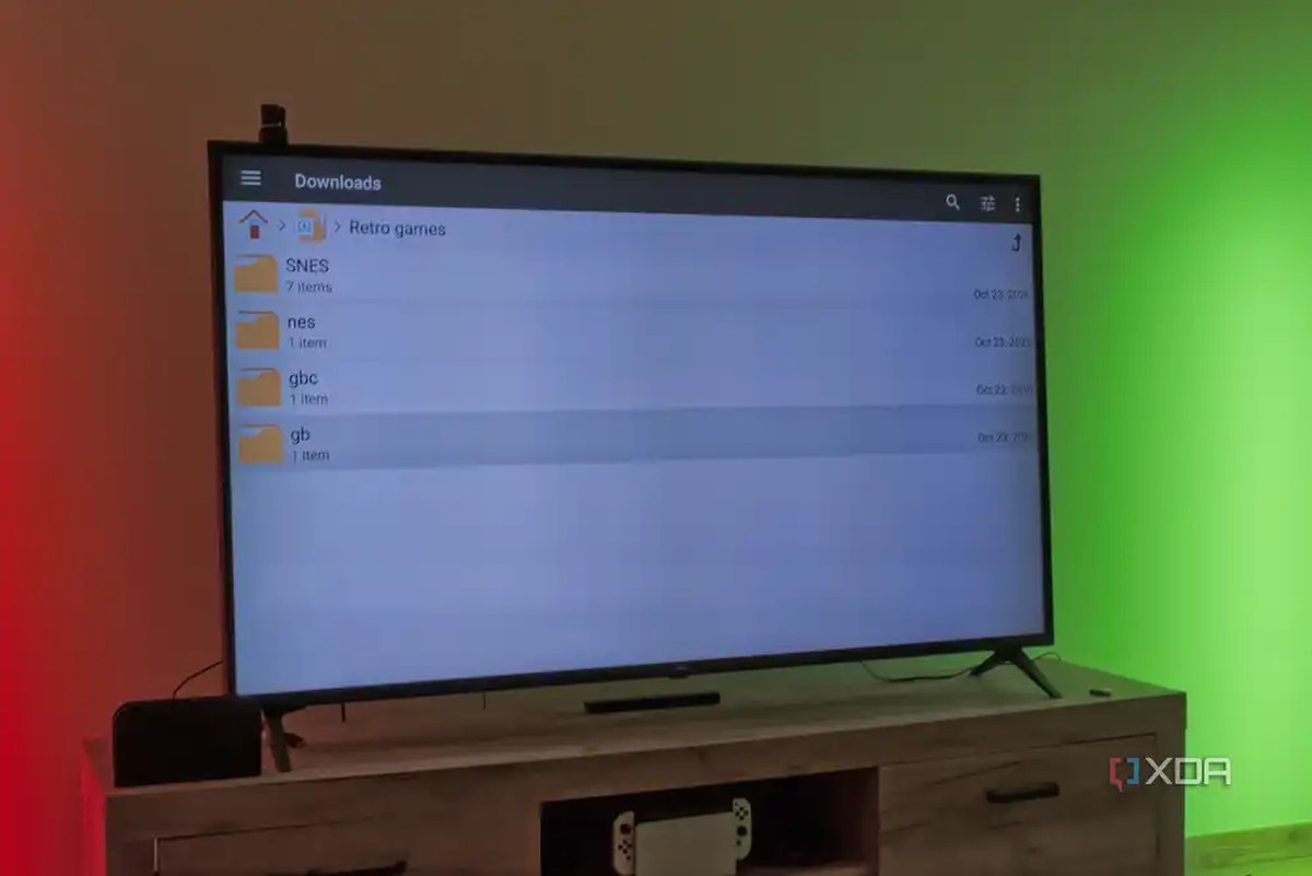 A TV displaying a file manager for Android TV, showing folders for ROMs for various game consoles