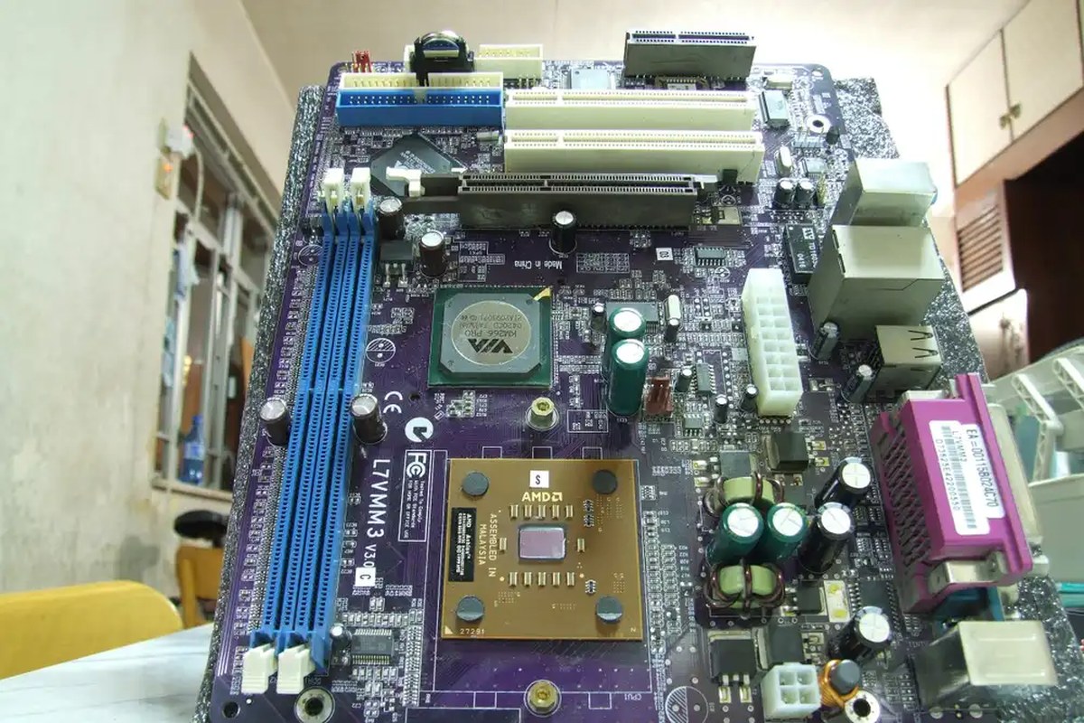 An ATX motherboard lying vertically on a white surface